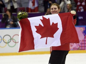 Canada 's flagbearer Hayley Wickenheiser holds up a Canadian flag following the medals cermony at the womens gold medal hockey game at the Sochi Winter Olympics Friday February 21, 2014 in Sochi, Russia. Canada defeated Team USA 3-2 to win the gold medal. Hayley Wickenheiser has retired from hockey after 23 years on Canada's women's team.The 38-year-old from Shaunavon, Sask., announced her retirement today.
