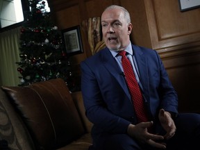 Premier John Horgan answers questions during a year end interview at his office at Legislature in Victoria on Tuesday.