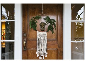 Front door wreath made from a needlepoint ring, yarn, and cedar boughs by Kendall Ansell Photo: Allison Kuhl for The Home Front: Applying fresh thought to traditional Christmas decor by Rebecca Keillor  [PNG Merlin Archive]