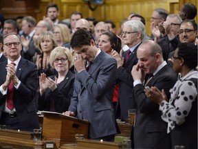 Prime Minister Justin Trudeau wipes his eye while he is applauded while making a formal apology to individuals harmed by federal legislation, policies and practices that led to the oppression of and discrimination against LGBTQ2 people in Canada, in the House of Commons in Ottawa on Nov. 28.