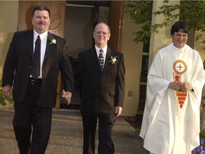 If Pride officials believe in inclusiveness, says Michael Kalmuk (left, in 2004), then they ‘cannot be exclusive of people we don’t like.’ Kalmuk and Kelly Montfort (centre) in 2004 were the first same-sex couple to be officially blessed in the worldwide Anglican Church. Priest Margaret Marquardt performed the rite.