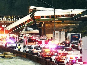 Cars from an Amtrak train that derailed above lay spilled onto Interstate 5 alongside smashed vehicles Monday, Dec. 18, 2017, in DuPont, Wash. (AP)