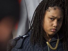 Honestie Hodges, 11, listens during a Greater Grand Rapids NAACP press conference at Calder Plaza in downtown Grand Rapids, Mich., on Tuesday, Dec. 19, 2017.