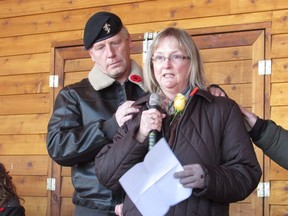 Shawn Stewart gives comfort to Leslie McArthur at the funeral of her brother former Master Cpl. Thomas McKenzie in Strathmore, Alta. on Saturday Dec. 9, 2017.