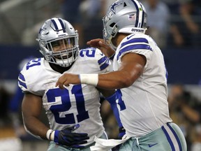 Dallas Cowboys' Ezekiel Elliott (21) and quarterback Dak Prescott (4) run off the field celebrating during an NFL football game against the Green Bay Packers in Arlington, Texas. Ezekiel Elliott returns to the Dallas backfield after serving his six-game suspension, the Cowboys went 3-3, winning the three most recent outings.