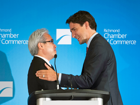 Justin Trudeau greets Paul Oei at a luncheon in Richmond, B.C., on July 24, 2015. Investors say Oei, a prominent immigration consultant, used photos of himself with Trudeau to prove his political clout.