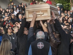 Leonard George's casket is hoisted aloft outside the Tsleil-Waututh Nation community centre in North Vancouver on Saturday.