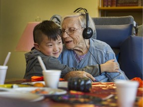 FILE PHOTO - 5 year old Tony Han Jr. with 100 year old Alice Clark at Youville Residence care facility in Vancouver, BC., October 26, 2016.