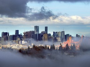 Environment Canada has issued a heavy fog advisory for the Metro Vancouver area on Monday morning. Vancouver's skyline can be seen through the fog in this Dec. 11, 2017 photo.