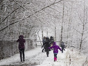 Children enjoy the first snowfall of the season in Coquitlam on Tuesday.