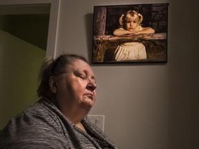 Lesley Gibson was forced out of affordable housing after a construction accident and is now fighting for compensation. The photo of her daughter in the background is one of her few remaining possessions.