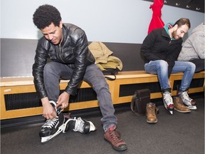 Tedros Gebrengus, a refugee from Eritrea, laces up a pair of skates at First Skate held at Rogers Arena, Vancouver, December 20 2017.