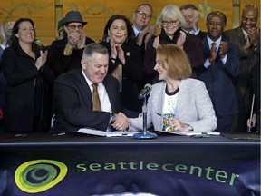 Seattle Mayor Jenny Durkan, right, shakes hands with Los Angeles-based Oak View Group CEO Tim Leiweke after they signed an agreement to renovate KeyArena on Wednesday (Dec. 6, 2017) in Seattle. Durkan said that the deal is the best path right now for Seattle to get an NHL team and bring back the SuperSonics.