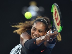 This file photo taken on Jan. 28, 2017, shows Serena Williams hitting a return against her sister Venus Williams during the women's singles final on Day 13 of the Australian Open tennis tournament in Melbourne. (PETER PARKS/AFP/Getty Images)