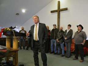 With friends and family standing behind him, Kentucky State Rep., Republican Dan Johnson addresses the public from his church regarding allegations that he sexually abused a teenager after a New Year's party in 2013. Timothy D. Easley/Associated Press