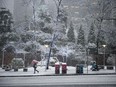 People on Burrard Street in downtown Vancouver on Tuesday, Dec. 19, 2017 during the first snow of the season.