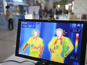 A thermal camera monitor shows the body temperature of visitors during the Job Fairs in Seoul, South Korea Friday, June 5, 2015.