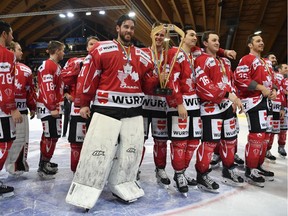 Team Canada celebrates with the trophy after winning the final game between Team Canada and Team Suisse at the 91st Spengler Cup ice hockey tournament in Davos, Switzerland, Sunday, Dec. 31, 2017. (Gian Ehrenzeller/Keystone via AP) ORG XMIT: DAV115