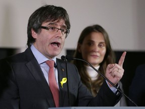 Ousted Catalan leader Carles Puigdemont gestures as he speaks during a during a press conference at the Square Meeting Center in Brussels on Thursday, Dec. 21, 2017. The pro-secession bloc won a majority in Catalan regional elections, but the anti-independence Ciutadans (Citizens), led by 36-year-old lawyer Ines Arrimadas, won the highest number of votes for a single party. Several members of the ousted Cabinet, including Puigdemont, have campaigned from Brussels, where they sought refuge from Spanish justice.