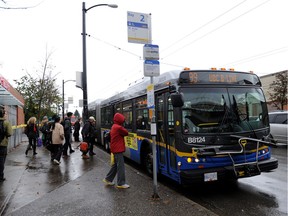 Commuters rush to catch the 99 B-line bus along Broadway Street in Vancouver.