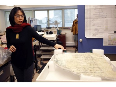 Curator Dr. Tzu-I Chung talks about a Chinese poem written on an immigration wall piece recovered from a building in 1912 near Fisherman's Wharf not yet on display at the Royal BC Museum in Victoria, B.C., on Thursday, December 21, 2017.