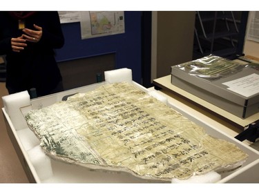 Curator Dr. Tzu-I Chung talks about a Chinese poem written on an immigration wall piece recovered from a building in 1912 near Fisherman's Wharf not yet on display at the Royal BC Museum in Victoria, B.C., on Thursday, December 21, 2017.