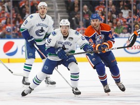 Edmonton's Zack Kassian tries to catch up to Vancouver's Michael Chaput during the first period of the game between the Canucks and Oilers at Rogers Place last April.