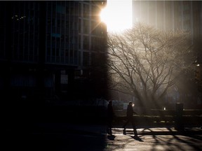 The sun shines through fog as people walk in downtown Vancouver on Wednesday, Dec. 6, 2017. More of the same is expected for the foreseeable future.