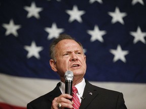 In this Dec. 5, 2017, photo, former Alabama Chief Justice and U.S. Senate candidate Roy Moore speaks at a campaign rally in Fairhope Ala. Moore has ignored all the rules of modern-day politics. But on the ground in Alabama, some believe the Republican Senate candidate is poised to win the state's special election on Tuesday in a race that features extraordinary parallels with President Donald Trump's White House run one year ago.