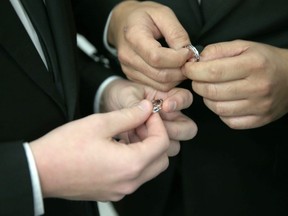 A couple exchange rings as they are wed during a wedding ceremony at the Broward County Courthouse on January 6, 2015 in Fort Lauderdale, Florida.