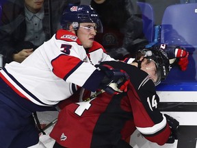 James Malm (14) of the Vancouver Giants is checked by Brennan Riddle (3) of the Lethbridge Hurricanes during their WHL game at the Langley Events Centre on Nov. 5, 2016.