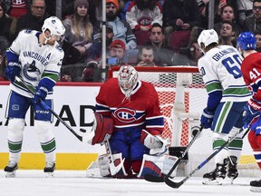 Goaltender Carey Price of the Montreal Canadiens makes a blocker save near Daniel Sedin (left) of the Vancouver Canucks during the NHL game at the Bell Centre on January 7, 2018 in Montreal, Quebec, Canada.