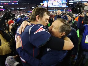 The two titans of the New England Patriots near two-decades success — quarterback Tom Brady and head coach Bill Belichick — embrace after last weekend’s AFC Championship Game win over the Jacksonville Jaguars at Gillette Stadium in Foxborough, Mass.