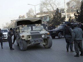 Policemen block the road to the Intercontinental Hotel during a deadly attack in Kabul, Afghanistan, Sunday, Jan. 21, 2018. Gunmen stormed the hotel and set off a 12-hour gun battle with security forces that continued into Sunday morning, as frantic guests tried to escape from fourth and fifth-floor windows.