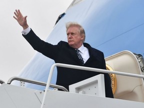 U.S. President Donald Trump waves as he boards Airforce One at Joint Base Andrews, Maryland on Jan. 12, 2018, for a weekend trip to Mar-a-Lago.