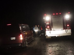 A van backs down the road as Tofino residents and visitors flood out of the community centre after the tsunami warning ends on Jan. 23. A tsunami warning issued for coastal B.C. was cancelled Tuesday morning after people living along parts of the West Coast evacuated to higher ground when a powerful earthquake struck off Alaska.