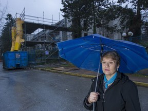 Katherine Munro outside her fire damaged code complex that received a 100 per cent assessment increase despite not being ready for habitation.
