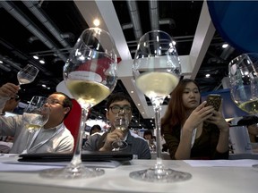 Visitors to a wine expo attend a tasting session for French wine in Beijing.  by 2020 China could become the world's second-largest wine consumer, behind the United States.