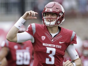 FILE - In this Sept. 17, 2016 file photo, Washington State quarterback Tyler Hilinski (3) runs onto the field with his teammates before an NCAA college football game against Idaho in Pullman, Wash. Hilinski has died from an apparent self-inflicted gunshot wound. The 21-year-old Hilinski was discovered in his apartment after he didn't show up for practice Tuesday, Jan. 16, 2018.