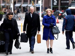 Laura Miller, second right,, deputy chief of staff to former Ontario premier Dalton McGuinty, arrives with her lawyer Scott Hutchison for closing arguments at court in Toronto on November 22, 2017. A judge is set to deliver his verdict today related to Ontario's gas-plants scandal. Former top political aides David Livingston and Laura Miller are charged over the destruction of documents.
