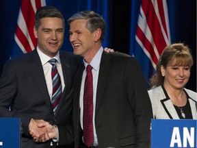 Todd Stone, left, and Andrew Wilkinson shake hands as Dianne Watts walks past after the B.C. Liberal leadership debate at the Weston Bayshore Hotel in Vancouver on Jan. 23.