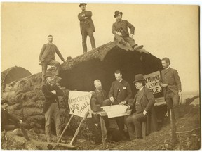 Pioneer Vancouver real estate salesman H.A. Jones (hatless on stump, left) poses with other early realtors on top of an old stump on Granville Street, 1886. The men in the photograph are, from left to right on ground: Edwin Sanders, A.W. Ross, Dr. Fort, J.W. Horne, Mr. Hendrickson, and U.S. Consul Mr. Hemming. Men on log are: H.A. Jones, Mr. Stiles, and an unidentified man. The photo was taken by H.T. Devine. This is an original 1880s print from the Vancouver Sun archives; somebody has done a bad crop on the print to make it fit into a file. The back of the print says it's "Property of Mrs. AH Berry."  Alice Helena Berry co-owned the Vancouver World from 1911 until her death in 1919. She was the daughter of Vancouver's first postmaster, Jonathan Miller, and later was married to Vancouver's longest-serving mayor, L.D. Taylor.