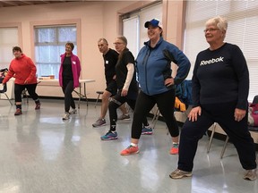 Participants in the 2018 Vancouver Sun Run InTraining Clinic take part in pre-workout stretches inside the Eric Bysouth Rotary Field House in Langley on Jan. 20.