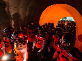B.C. Lions players wait in an inflatable tunnel before a CFL football game against the Montreal Alouettes in Vancouver, B.C., on Friday September 8, 2017.