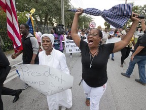 Haitian-Americans protest Donald Trump’s “shithole countries” remarks as they march in Miami on Jan. 12 to commemorate the eighth anniversary of the Haitian earthquake.