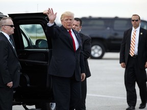 President Donald Trump waves as he arrives to board Air Force One at Palm Beach International Airport, Monday, Jan. 1, 2018, in West Palm Beach, Fla., to return to Washington.