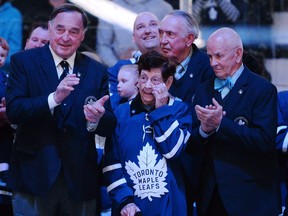 Nancy Bower, wife of the late Hockey Hall of Famer Johnny Bower, watches a tribute to her husband with three of his former Toronto Maple Leafs teammates — Frank Mahovlich, left, Bob Nevin (behind Nancy Bower) and Dave Keon, right — prior to the Leafs’ NHL game against the Tampa Bay Lightning at Toronto’s Air Canada Centre on Jan. 2, 2018.