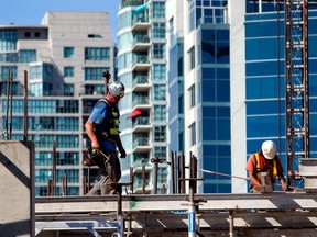 Contractors work on a condo being built in Vancouver.