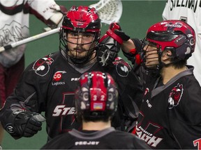 Vancouver Stealth Corey Small celebrates his goal on the Colorado Mammoth with teammates James Rahe, foreground, and Jordan Durston, right, in a regular-season NLL game at the Langley Events Centre on April 22, 2017.
