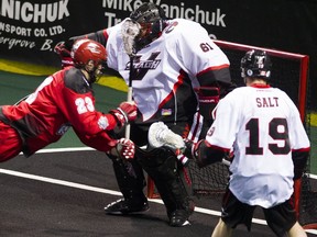 Eric Penney of the Vancouver Stealth attempts to make a save against the Calgary Roughnecks in NLL action on Feb. 20, 2016 at Langley Events Centre.